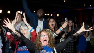 JoAnn Loulan, center, reacts with her mother-in-law, Sydney Crawford, at left, after Democrats gained control of the House of Representatives 