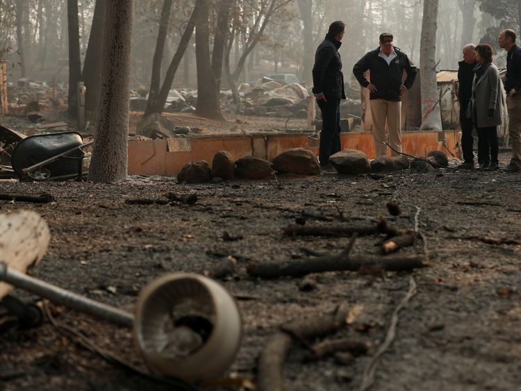 U.S. President Donald Trump visits the charred wreckage of Skyway Villa Mobile Home and RV Park with Governor-elect Gavin Newsom (L), Brock Long (R), Paradise Mayor Jody Jones (2nd R) and Governor Jerry Brown in Paradise, California, U.S., November 17, 2018. REUTERS/Leah Millis
