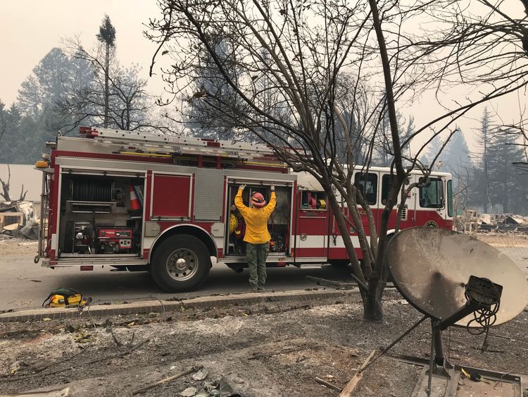 A firefighter works in one of the areas burned out in Paradise