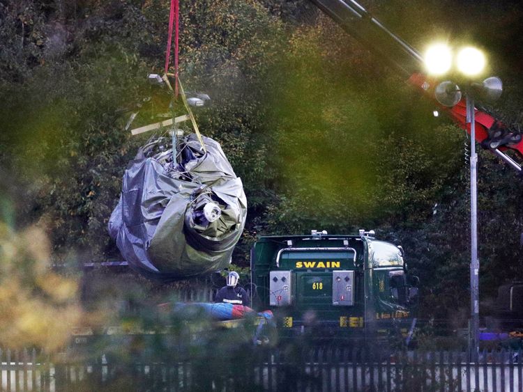 Crane moves helicopter wreckage