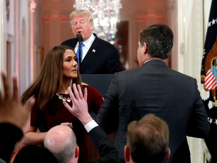 CNN's Jim Acosta refuses to relinquish the microphone to a White House staffer