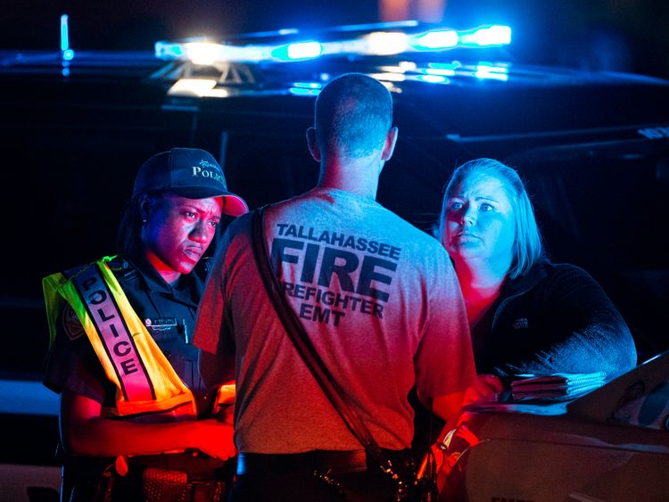 Emergency services workers outside the HotYoga Studio where a gunman shot two people and injured five others