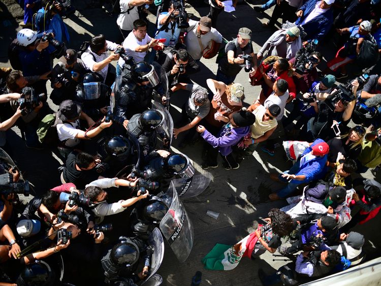 Several hundred migrants push past a blockade of Mexican police