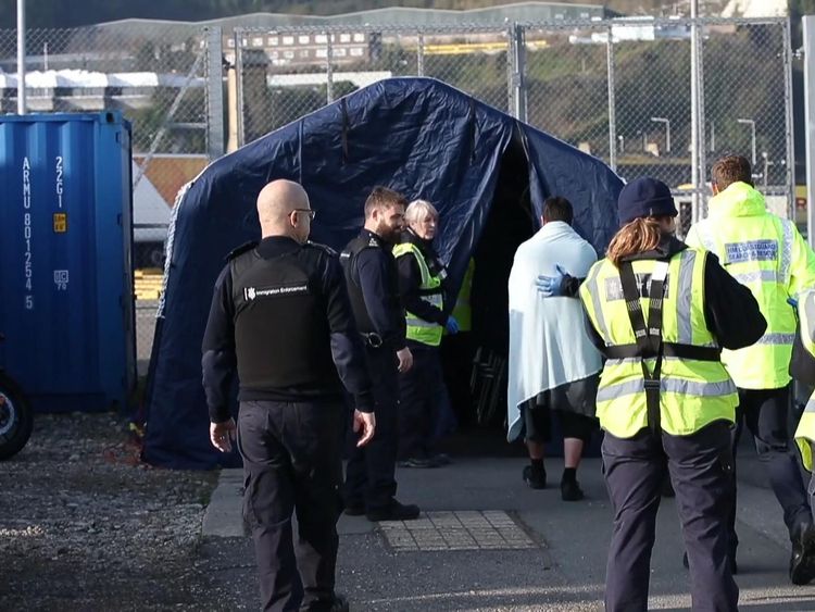 One of the migrants is escorted at Dover