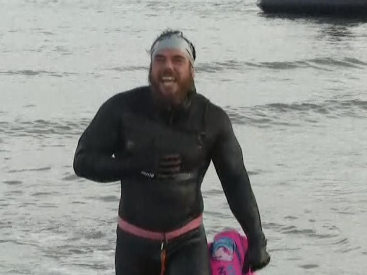 Ross Edgley emerges from the water at the end of his marathon swim