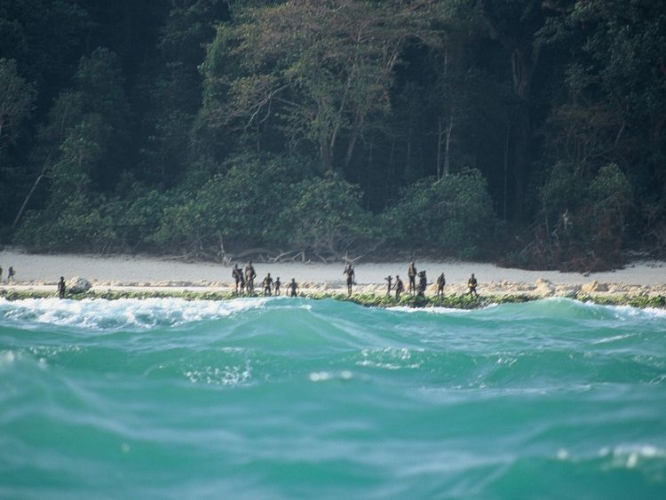 The Sentinelese stand guard on an island beach. Pic: © Christian Caron – Creative Commons A-NC-SA