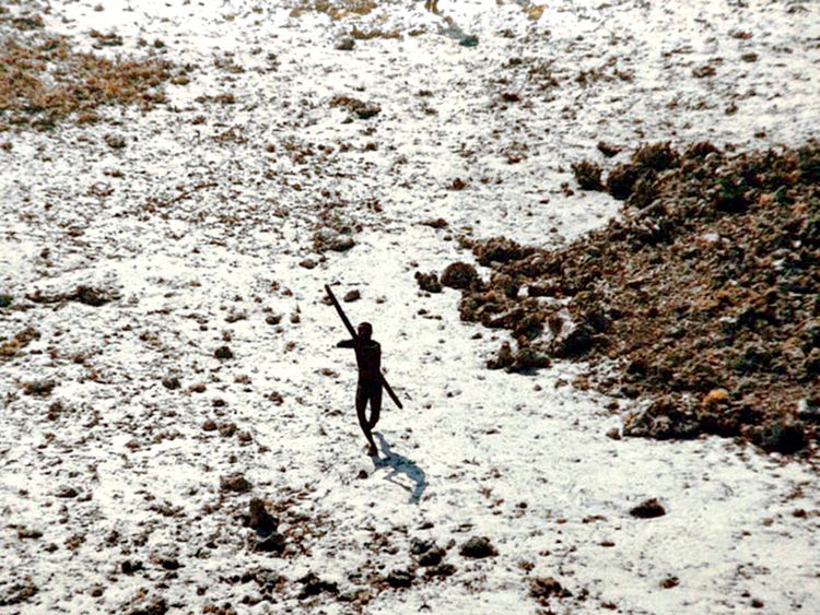 In the wake of the 2004 tsunami this member of the Sentinelese tribe was photographed firing arrows at a helicopter. Pic: © Indian Coastguard/Survival