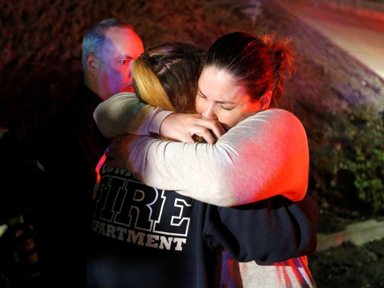 People comfort each other outside the bar 