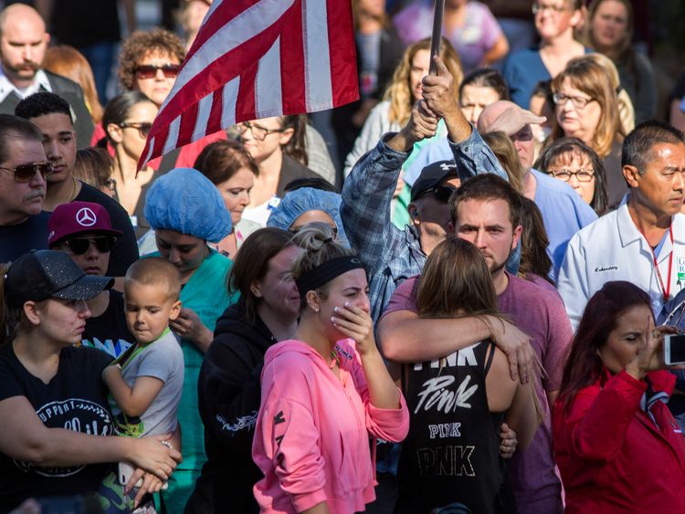 People watch the procession carrying the body of Ventura County Sheriff Sgt Ron Helus