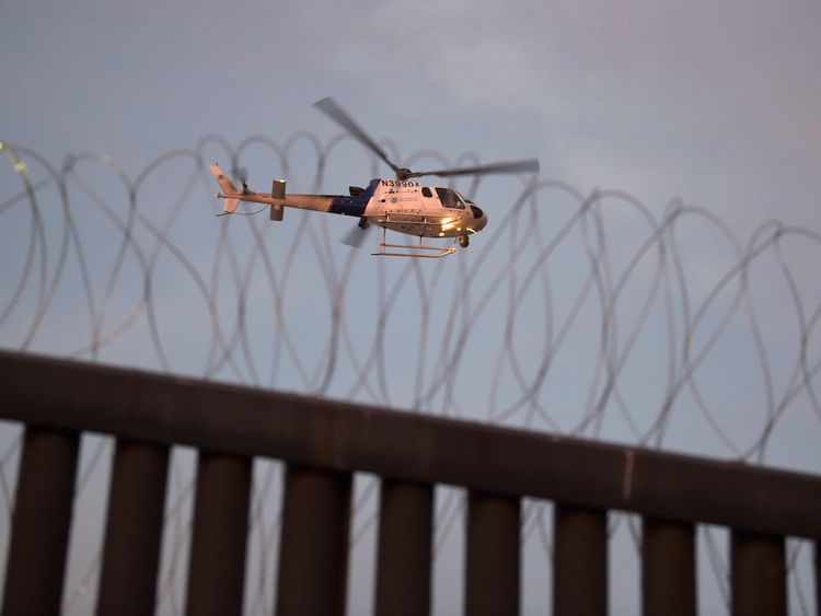 A US helicopter patrols the border with Mexico at Tijuana