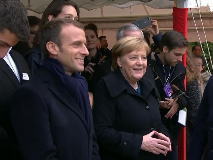Mr Macron and Ms Merkel at a cemetery in France