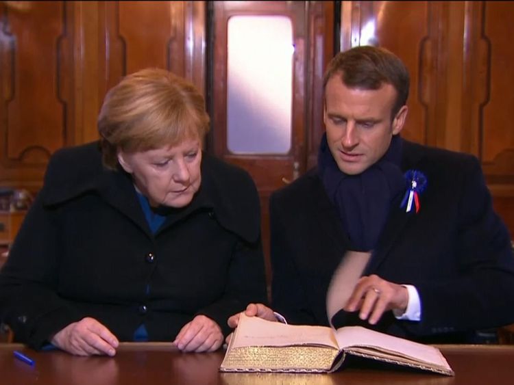 Mr Macron and Ms Merkel in the railway carriage where the Armistice was signed