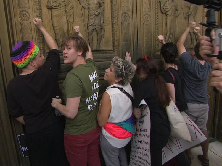People bang on the door of the Supreme Court to protest against the appointment of Brett Kavanaugh