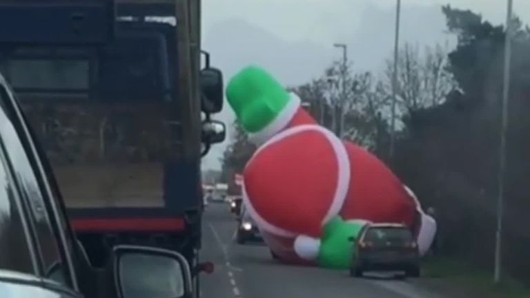 Inflatable Santa causes traffic.