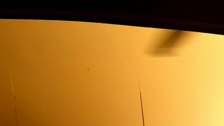 A helicopter rescues people from a mountain top in Malibu during California wildfires 