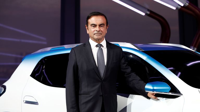 Carlos Ghosn, Chairman and CEO of the Renault-Nissan Alliance, poses with an electric show car called Renault K-ZE prior the opening of the Paris auto show in Paris, France October 1, 2018