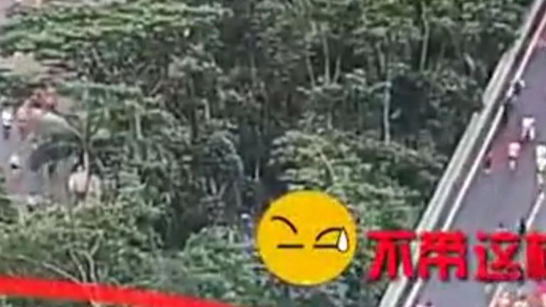 Police camera catches scores of marathon runners cheating by using a short cut during a half marathon in China