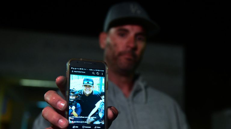 Jason Coffman shows a photo of his son Cody who was at the bar but has not been seen.