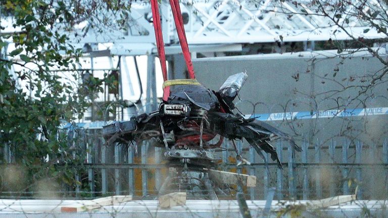 Crane moves helicopter wreckage