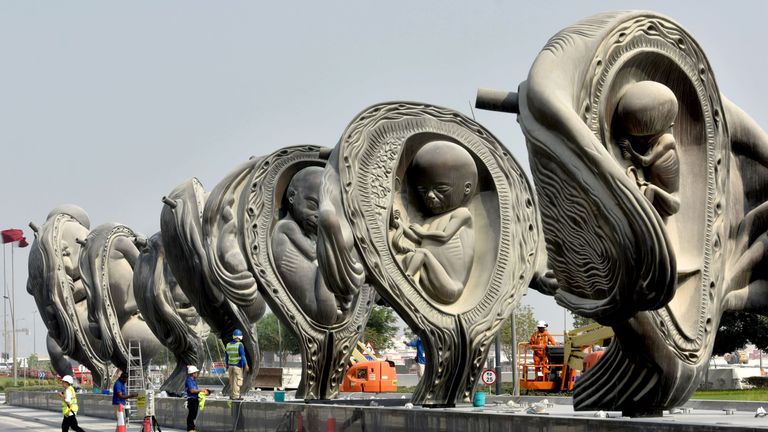 Workers operate on &#39;The Miraculous Journey&#39;, an art installation by artist Damien Hirst outside the Sidra Medical & Research Centre in Qatar&#39;s capital Doha, on the day of their unveiling on October 10, 2018.