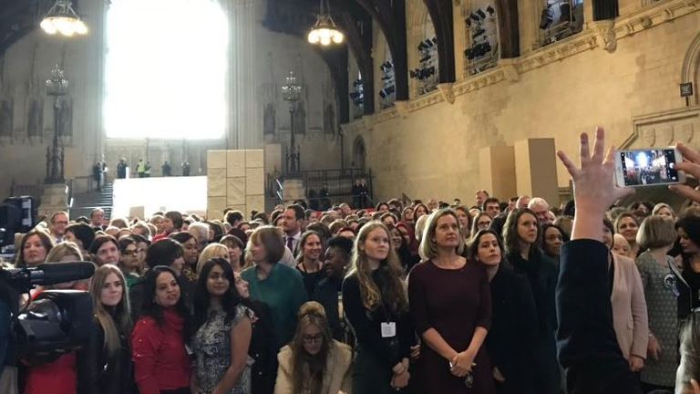 Women MPs pose with people attending the event 
