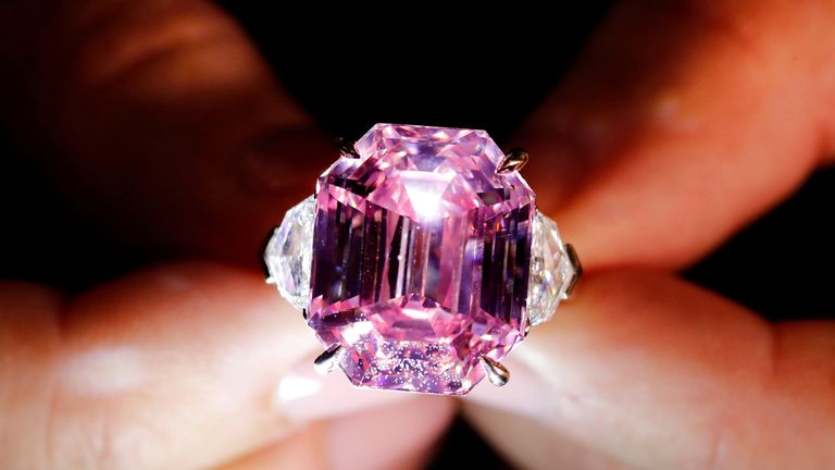 FILE PHOTO: A Christie&#39;s staff holds a 18.96 carat Fancy Vivid Pink Diamond during a preview in Geneva, November 8, 2018. REUTERS/Denis Balibouse/File Photo