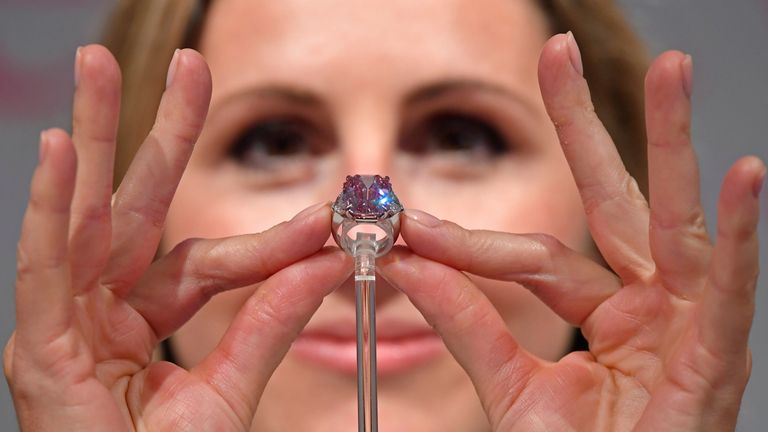 Jewellery Specialist at Christie&#39;s, Rachel Evans-Omeyer, poses with an 18.96 carat Fancy Vivid Pink Diamond prior to it being auctioned in November in Geneva, at Christie&#39;s in London, Britain, September 25, 2018. REUTERS/Toby Melville