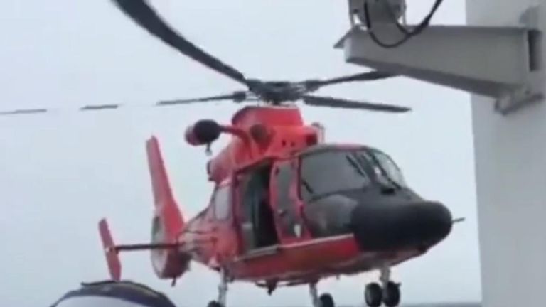 US Coast Guard rescue helicopter makes skilful landing at sea in bad weather 