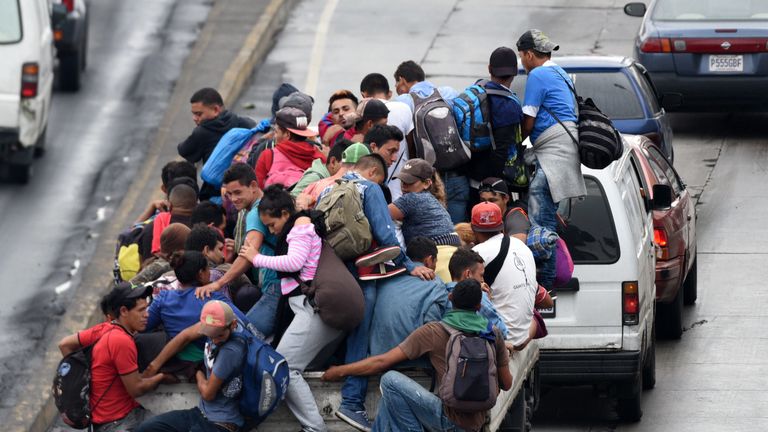  Honduran migrants aboard vehicles head in a caravan to the United States, in Guatemala City, on October 18, 2018