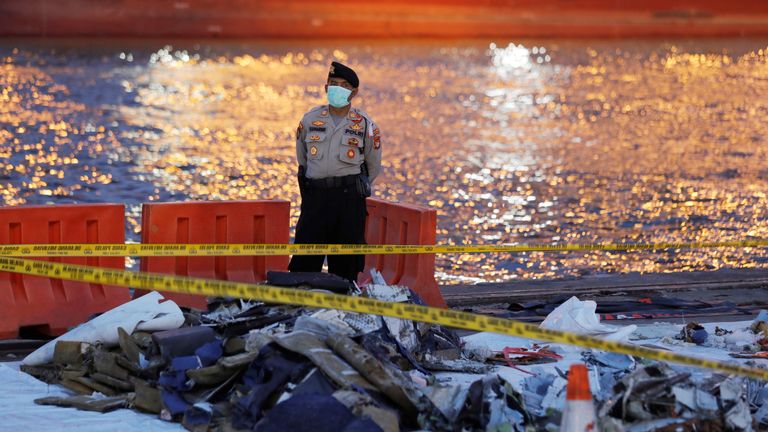 A policeman stands guard near the wreckage of Lion Air&#39;s flight JT610 at Tanjung Priok port in Jakarta