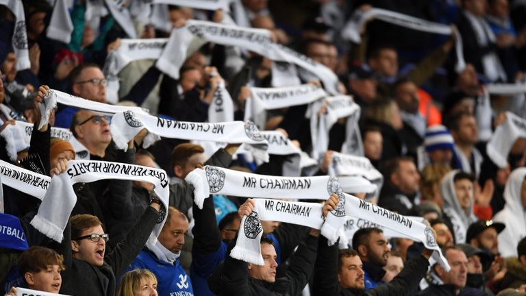 Leicester fans hold up their commemorative scarves