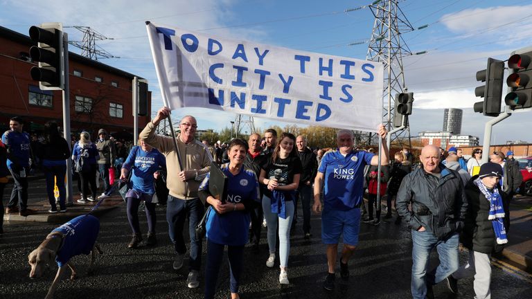 Fans carry a banner saying &#39;today this city is united&#39; as thousands march to the stadium