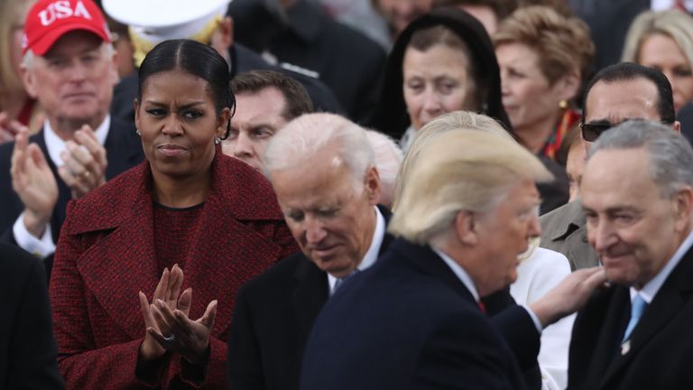 U.S. first lady Michelle Obama (L) watches as incoming President Donald Trump speaks 