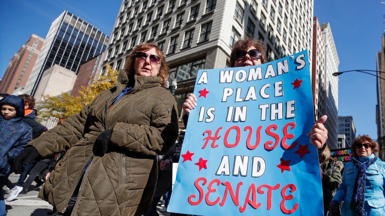 A woman holds a sign during a rally to inspire voter turnout ahead of the midterms