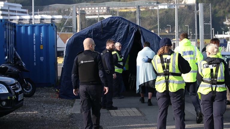 One of the migrants is escorted at Dover