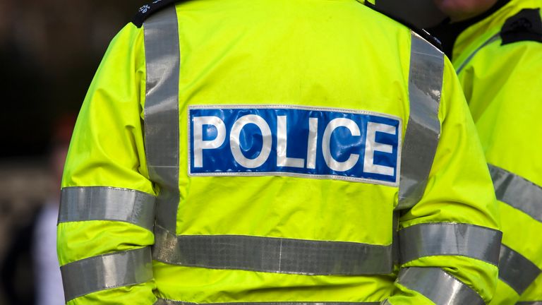 Shot of the back of a police officer&#39;s jacket with the word police written across the back