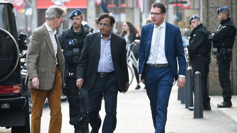 Pakistani lawyer Saiful Mulook (C), escorted by the police, arrives at The Hague after fleeing Pakistan