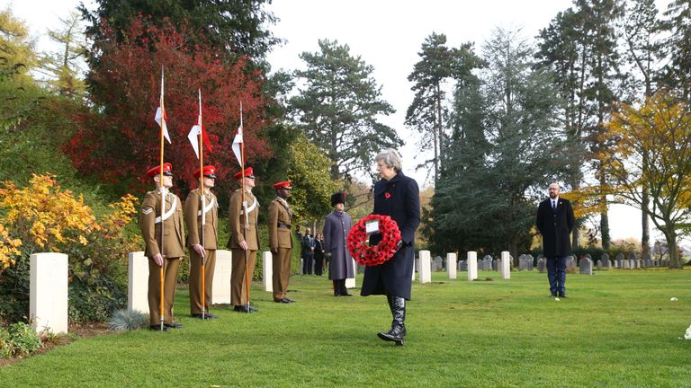 Theresa May lays a wreath at the graves of John Parr, the first British soldier to be killed in 1914, and George Ellison, the last to be killed
