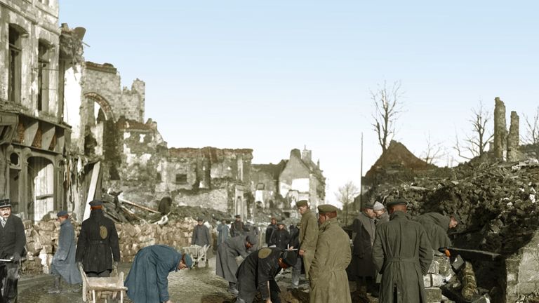 German prisoners of war, under British guard, mending the road and clearing rubble in the northern French town of Bethune, near the former Western Front