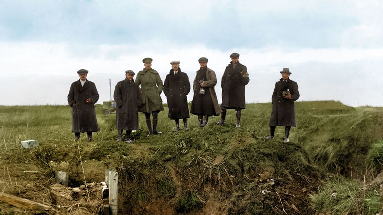 Journalists and photographers from various news agencies at a machine gun post in an abandoned German trench, part of the series of fortifications on the Western Front known as the Hindenburg Line