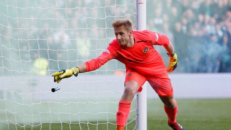 Hearts goalkeeper Zdenek Zlamal went down under a challenge from a fan. File pic