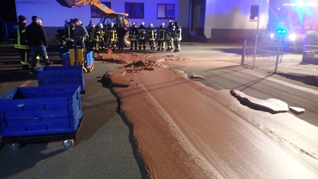 Spilt chocolate is cleared from a road in Werl Germany
