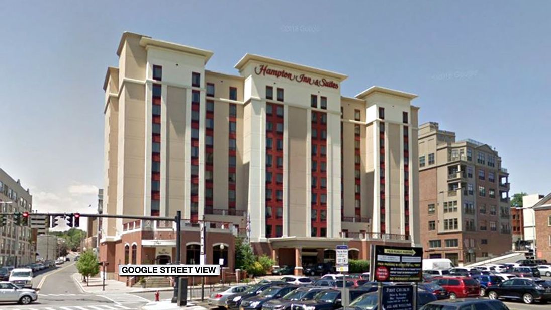 The woman says she was filmed in the shower of the Hampton Inn and Suites in downtown Albany, NY