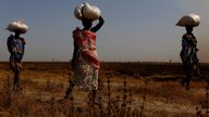 Women carry sacks of food in Thonyor, Leer State, South Sudan, 