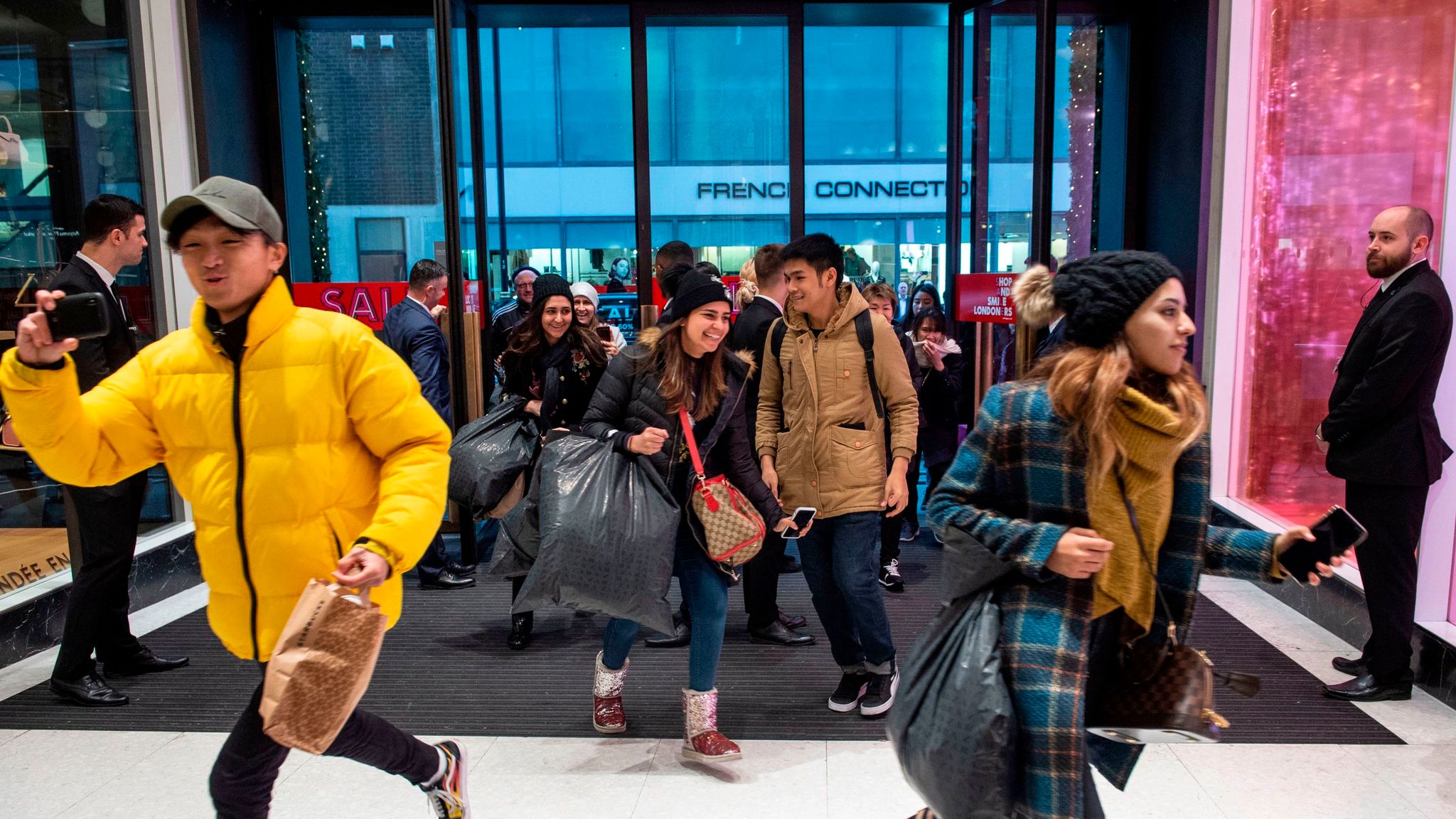Shoppers queue outside Selfridges on Oxford Street, London before