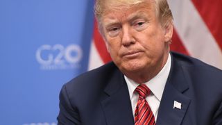 US President Donald Trump gestures during a bilateral meeting with Germanys Chancellor Angela Merkel, on the sidelines of the G20 Leaders' Summit in Buenos Aires, on December 01, 2018