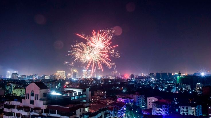Fireworks explode over the city during New Year celebrations in Yangon on January 1, 2019. (Photo by YE AUNG THU / AFP) (Photo credit should read YE AUNG THU/AFP/Getty Images)
