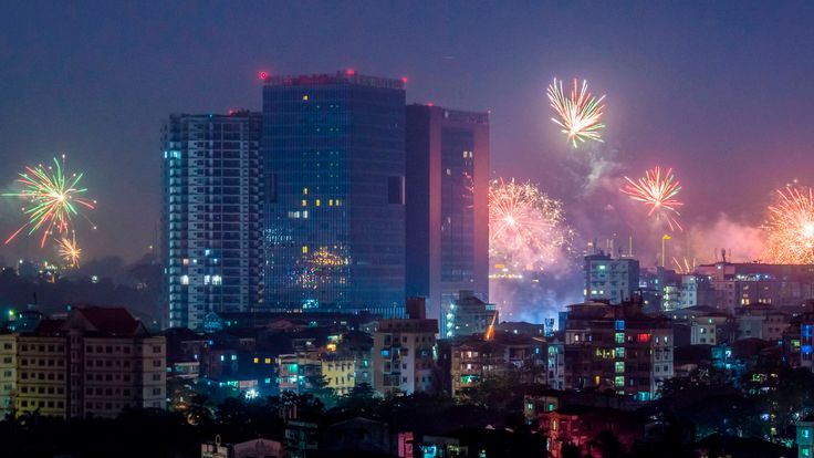 Fireworks explode over the city during New Year celebrations in Yangon on January 1, 2019. (Photo by YE AUNG THU / AFP) (Photo credit should read YE AUNG THU/AFP/Getty Images)

