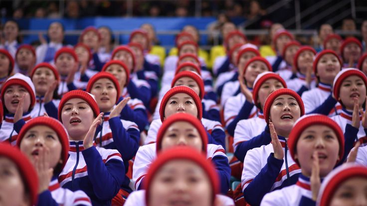 North Korean cheerleaders watch the united Korea&#39;s ice hockey team at the winter Olympics 