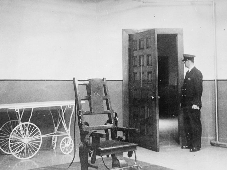 A prison guard stands in the Electric Chair room at Sing Sing Prison, New York, in 1951